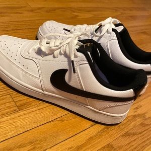 White Nike shoes with black swooshes